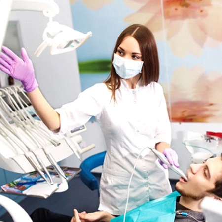 A dentist performing an oral exam.